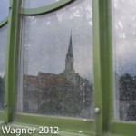 Church mirroring in the window of the Palmenhaus